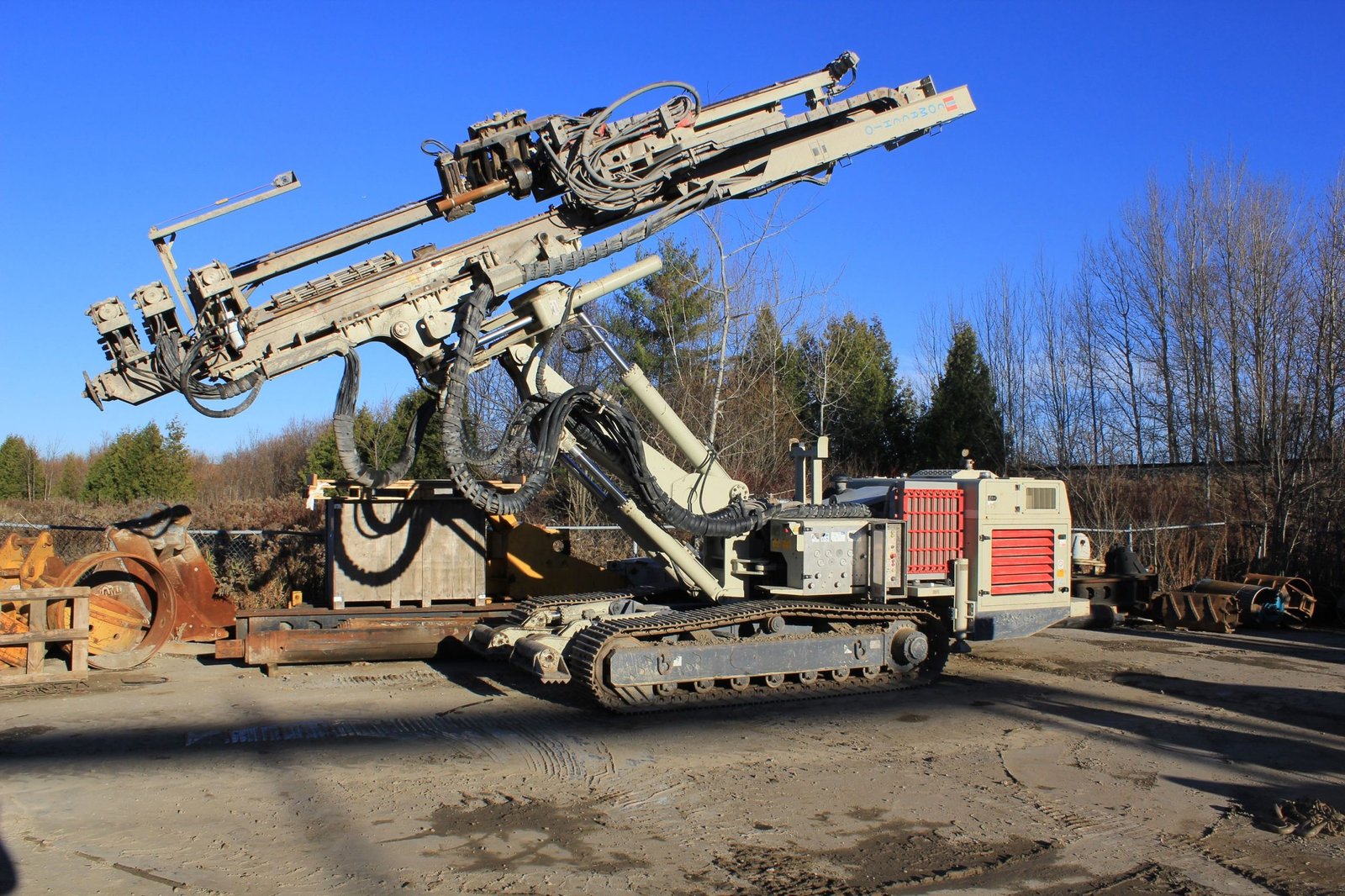 Tracked construction equipment parked on a job-site equipment yard